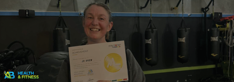 Joanne holding a certificate of recognition for her effort and commitment at AB Health & Fitness gym