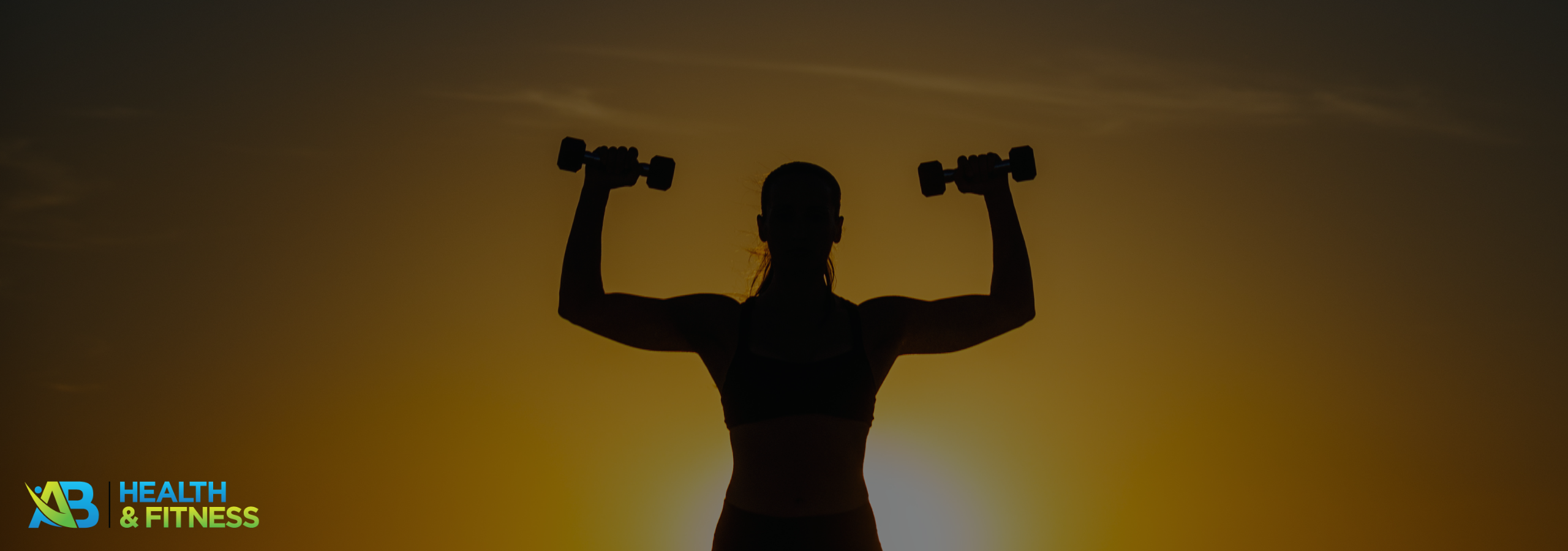 Silhouette of a woman lifting dumbbells at sunrise during a workout, highlighting March fitness and strength.